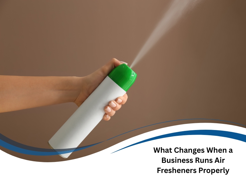 A hand sprays an aerosol can. This image promotes wholesale air fresheners benefits for businesses.