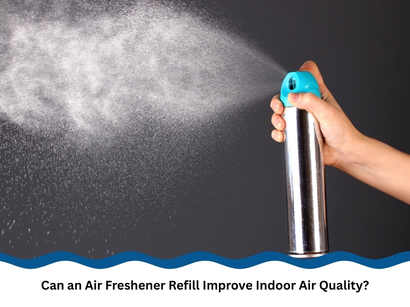 Hand spraying air freshener refill mist into the air to improve indoor air freshness.