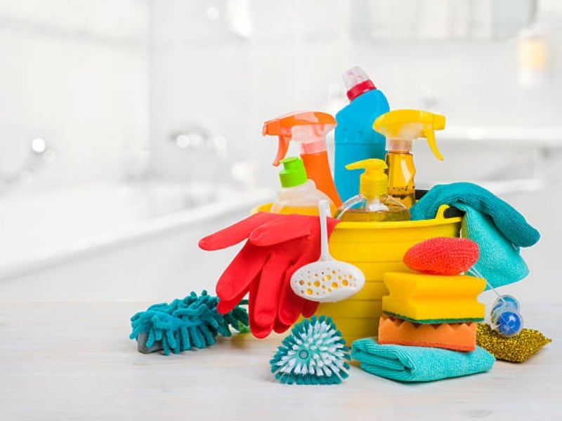 Essential cleaning supplies for a cleaning business including gloves, sprays, sponges, and brushes.
