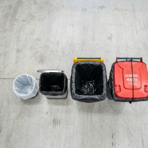 Assorted Australian workplace bins showing correctly fitted garbage bags of various sizes and micron ratings.