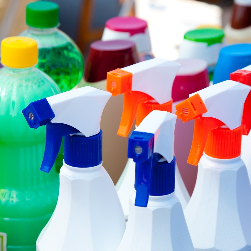 Assorted spray bottles and containers representing professional cleaning chemicals Sydney businesses use for commercial and workplace maintenance.
